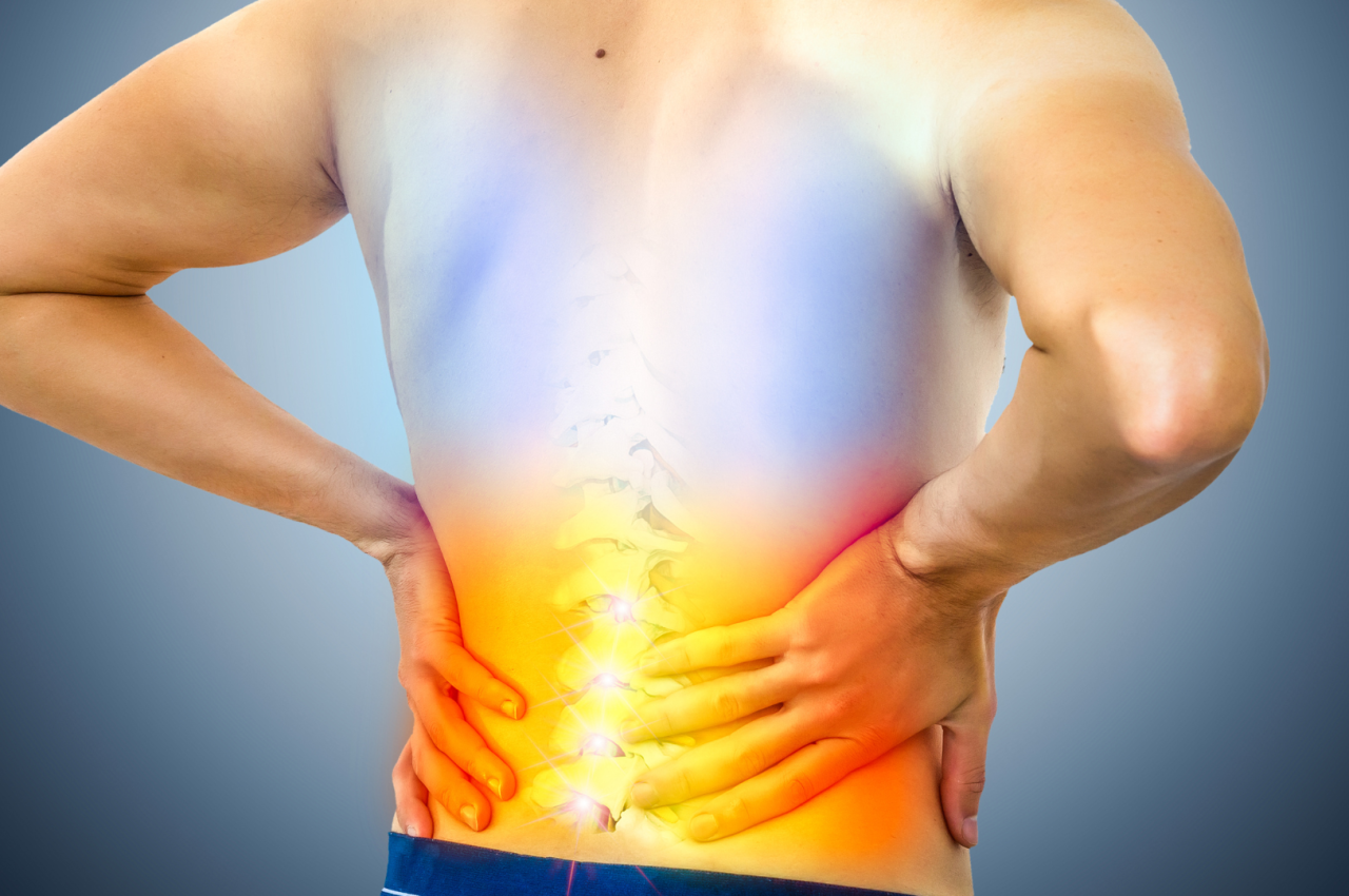 Indian man experiencing lower back pain at a clinic in panchkula